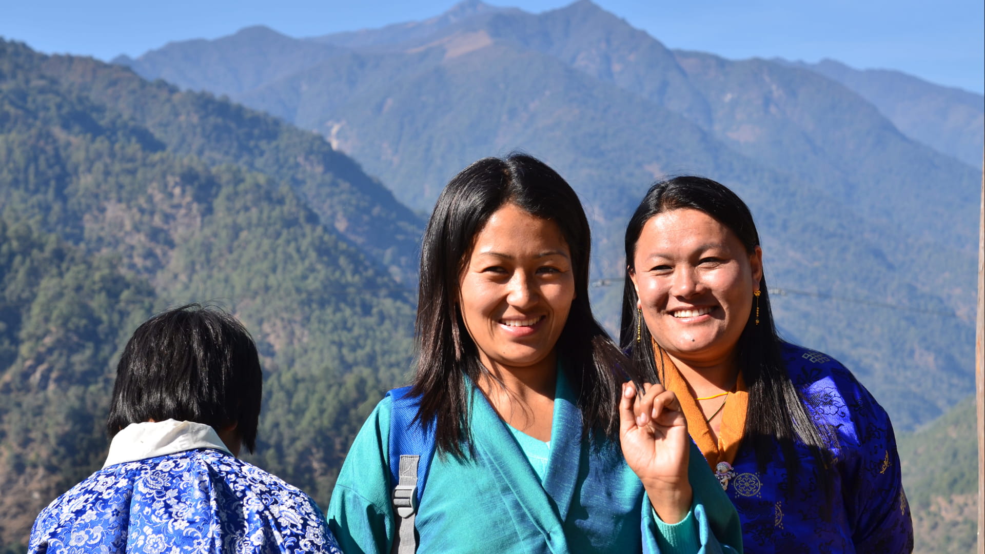 Bhutan women in front of a mountain range