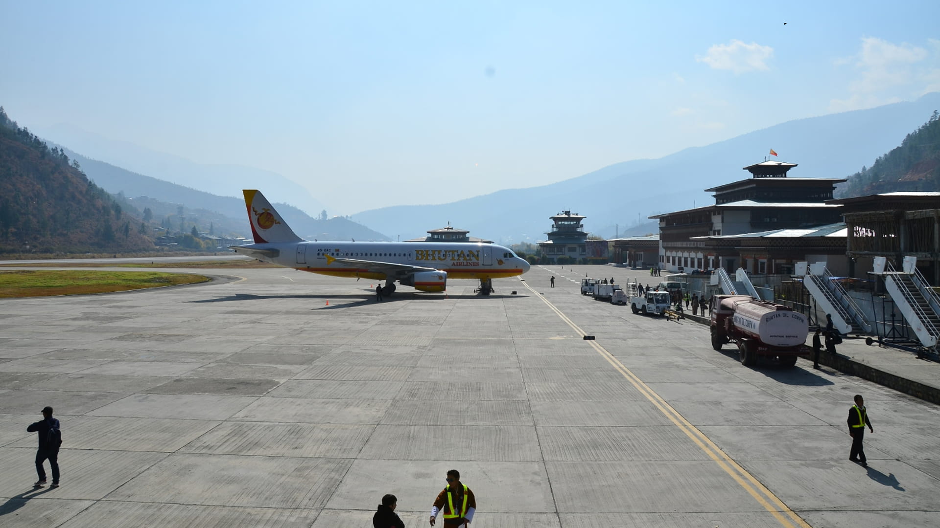 Flugzeuge, die auf der atemberaubenden Landebahn des Paro International Airport landen, die von hohen Bergen umgeben ist.
