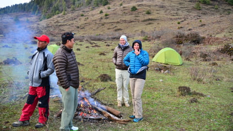 Images of groups of trekkers gathering around a campfire to share stories and enjoy nature together